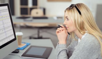Female accountant looking at excel spreadsheet